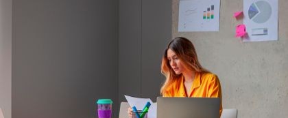 Woman looking at laptop while sitting at table