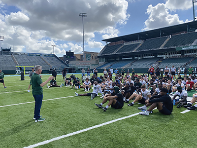 Dean Bordnick talks to the Tulane football team about virtual reality and mental health