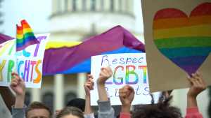protest signs including rainbow heart and Respect LGBT rights