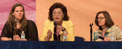 three women on stage during panel discussion